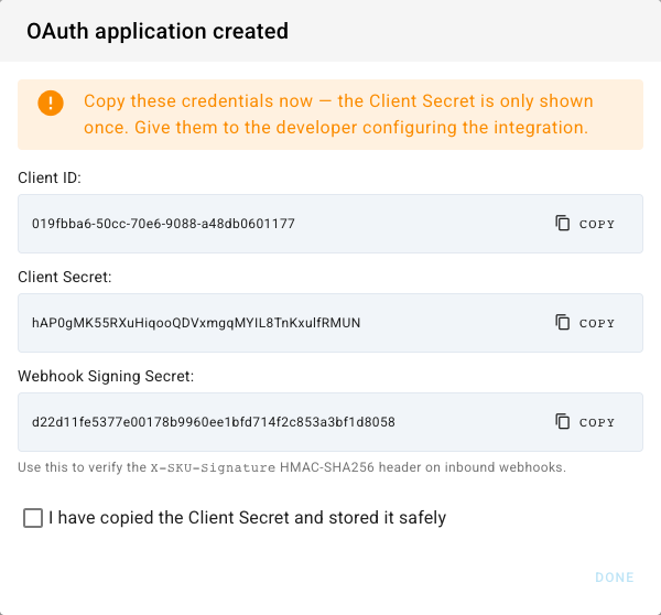 The OAuth application created dialog showing the Client ID, Client Secret, and Webhook Signing Secret with copy buttons