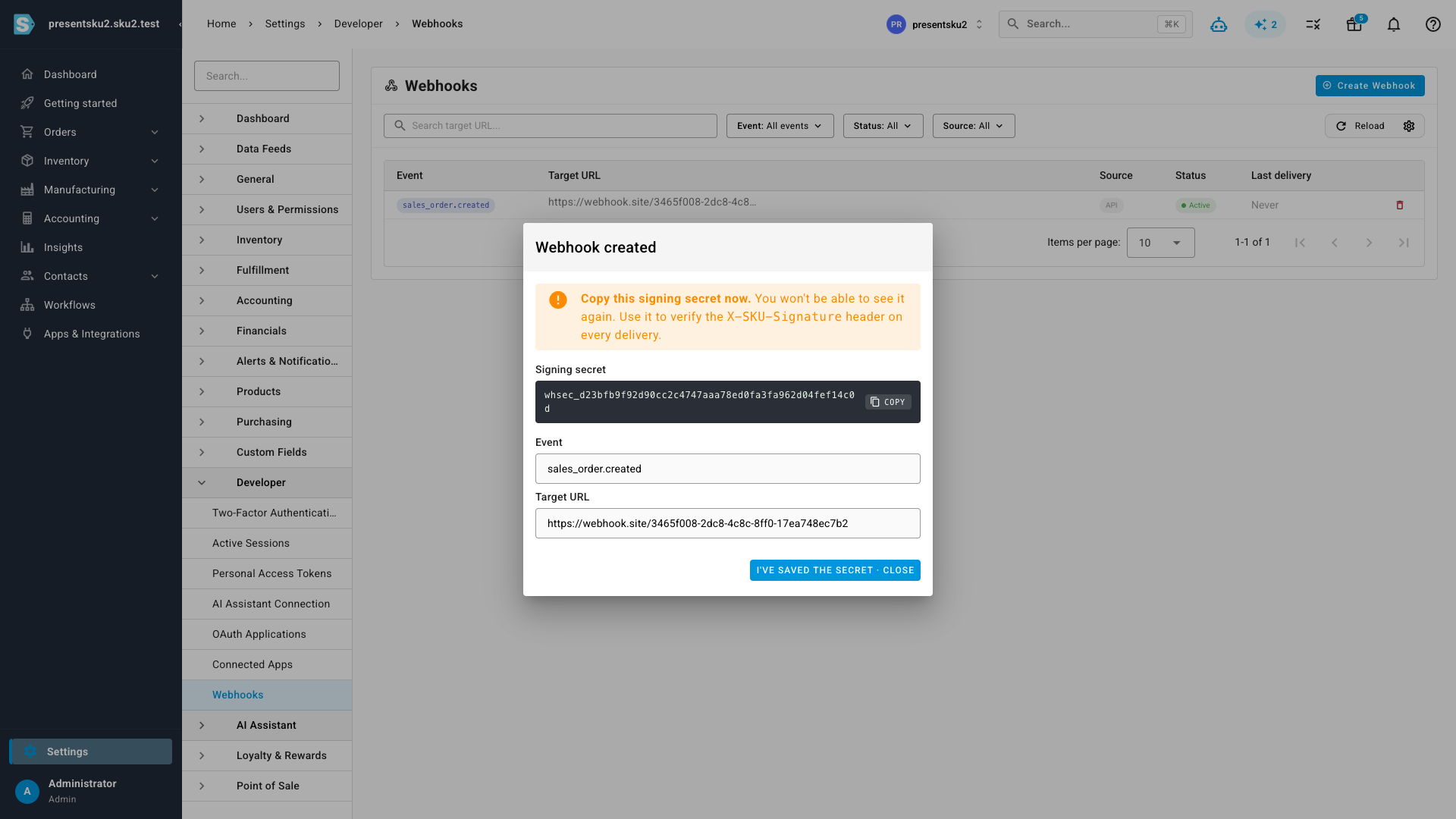 The webhook-created dialog showing the one-time signing secret with a copy button